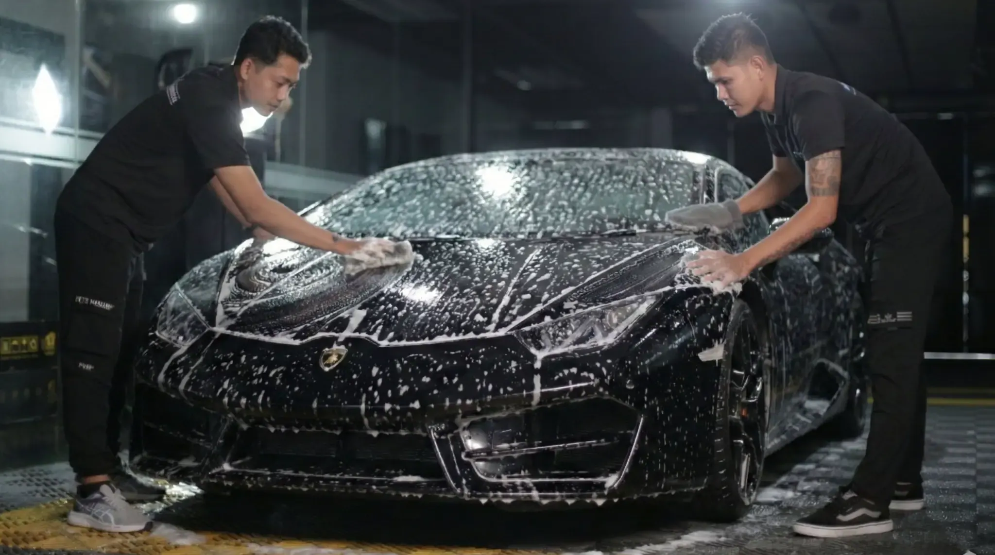 QUAD Film installer preparing a car panel before applying film
